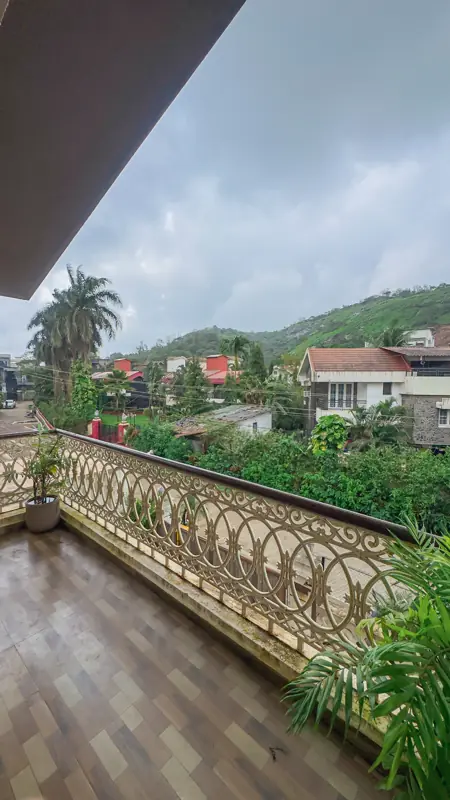 Balcony with ornate railing and greenery