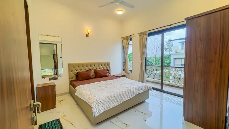 Bedroom with a large window and wardrobe