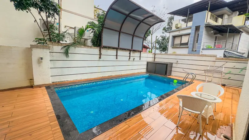Sparkling blue private pool with lounge chairs